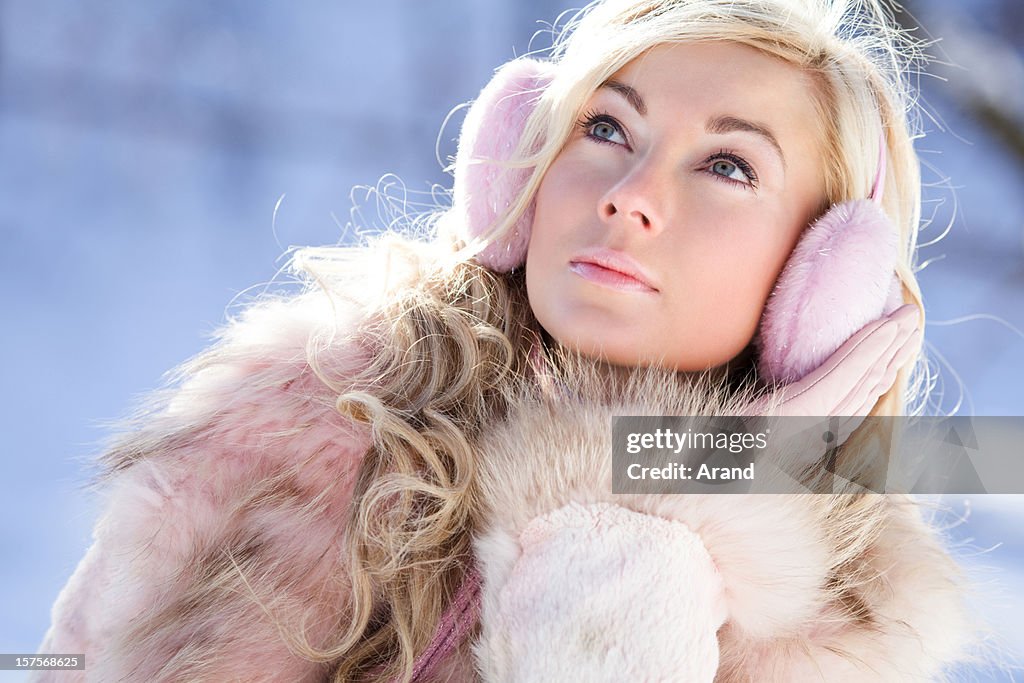 Young blonde woman in ear muffs