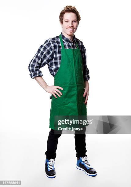 smiling man wearing green apron - grocer stock pictures, royalty-free photos & images