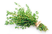 Fresh thyme bunch tied up shot on white backdrop
