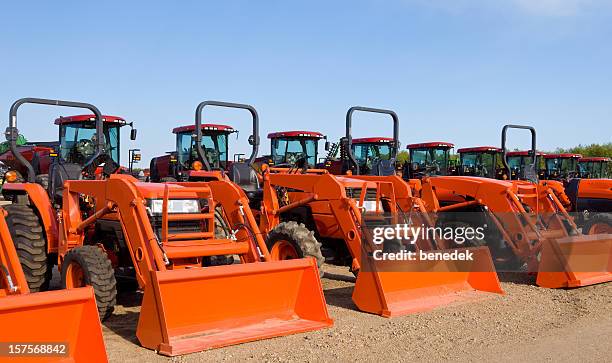 front loader tractors, tractor park - construction equipment stock pictures, royalty-free photos & images