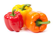 Three bell peppers, a red, a yellow and an orange one