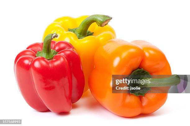 three bell peppers, a red, a yellow and an orange one - pepper stock pictures, royalty-free photos & images