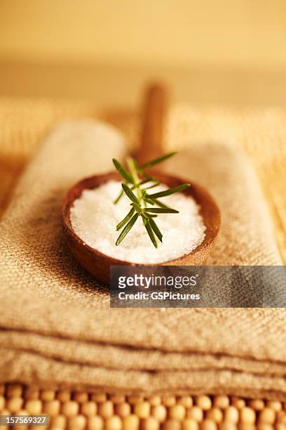 rosemary auf bath salt scrub in wooden spoon - bath salt stock-fotos und bilder