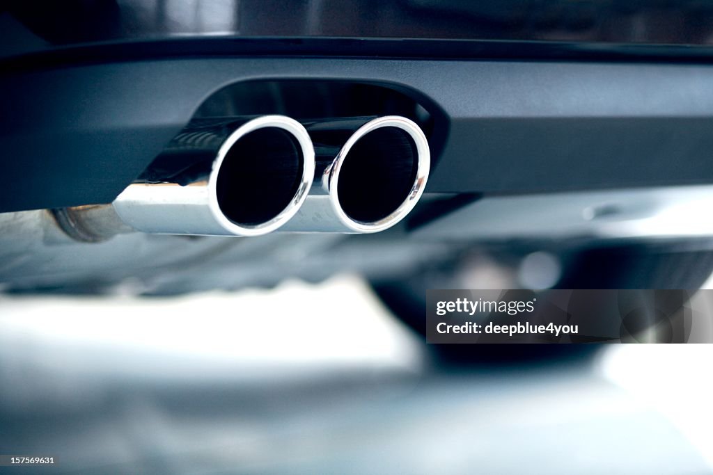 Stainless steel exhaust pipes on a blue car