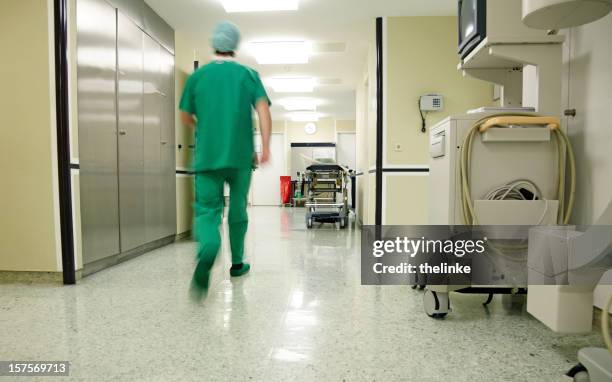 surgeon hurrying along a hospital floor - maternity hospital stock pictures, royalty-free photos & images