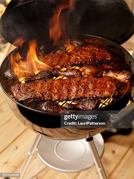 ribs and chicken on a charcoal bbq - barbeque sauce stock pictures, royalty-free photos & images