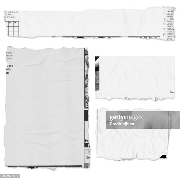 four pieces of a torn newspaper page on white background - krant stockfoto's en -beelden