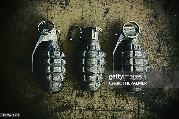 hand grenades on scratchy rusty background - detonator stock pictures, royalty-free photos & images