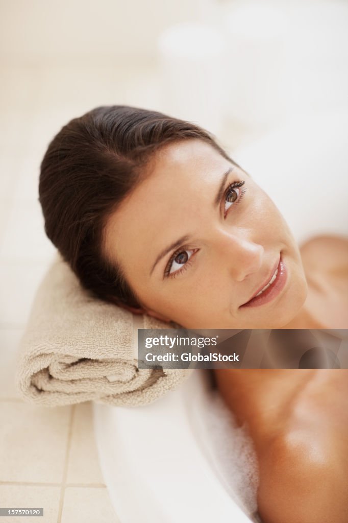 Woman relaxing in her bath tub