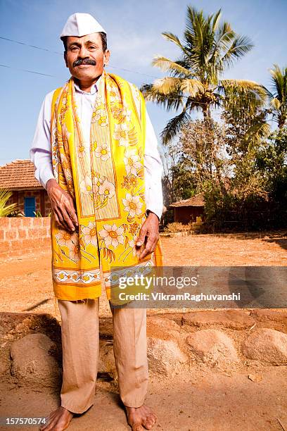 one cheerful traditional rural indian man male standing vertical - topi cap stock pictures, royalty-free photos & images