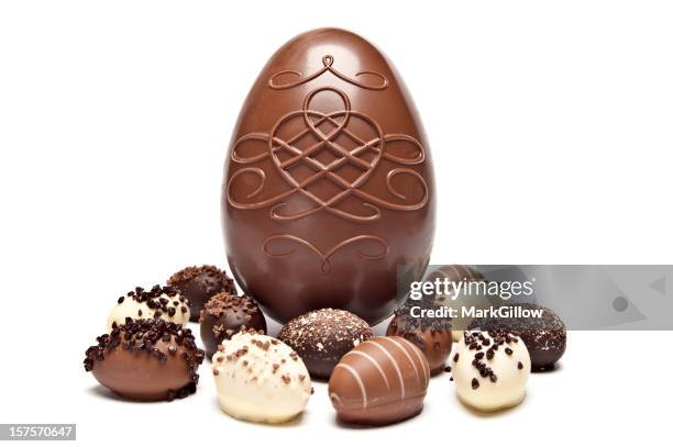 one large chocolate egg surrounded by little chocolate eggs - easter egg chocolate stock pictures, royalty-free photos & images