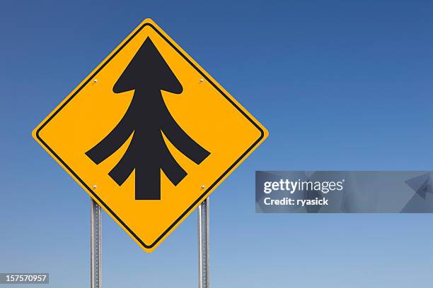 convergence or multiple merges ahead traffic sign post over sky - merging sign stockfoto's en -beelden