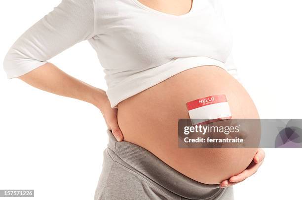 pregnant woman with name tag on bare belly - identity stock pictures, royalty-free photos & images