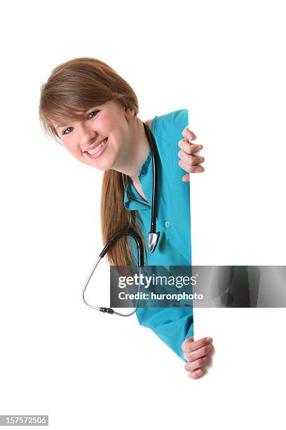 nurse peeking around sign - gluren stockfoto's en -beelden