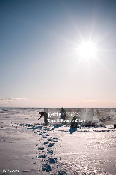 arctic ice fishing, yellowknife, northwest territories, canada. - yellowknife canada stockfoto's en -beelden