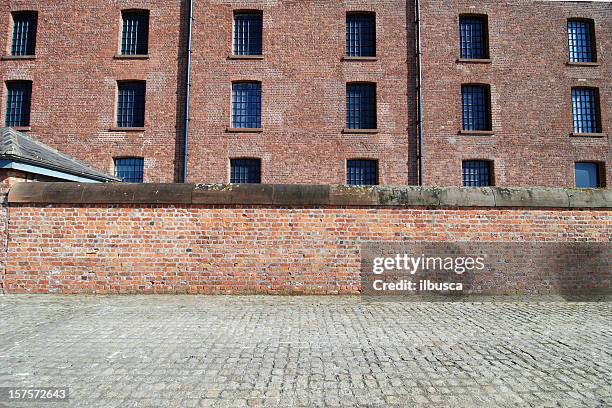 red brick wall with sidewalk at the albert dock, liverpool - red brick wall stock pictures, royalty-free photos & images