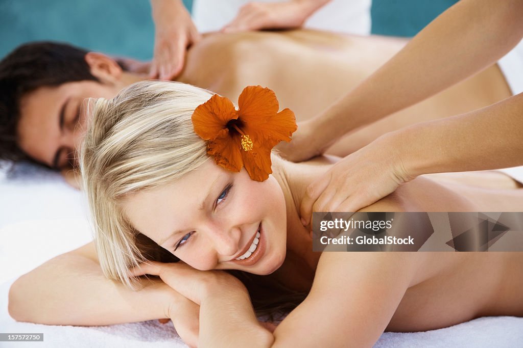 Happy couple getting a body massage together