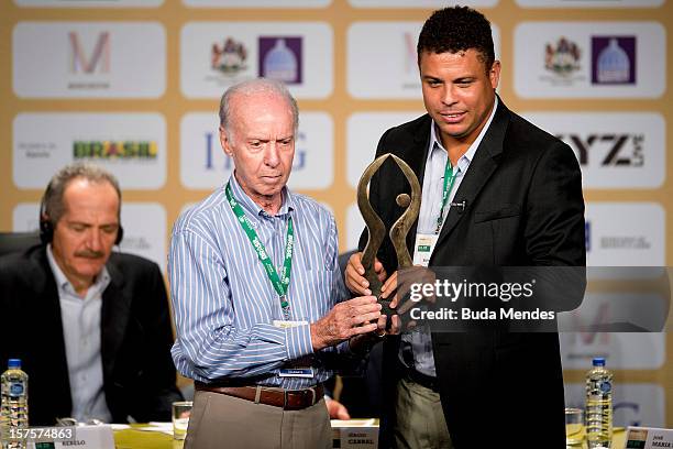 Ronaldo, former football star, poses with Mario Jorge Lobo Zagallo, former football player and coach, after receiving a trophy for his career during...