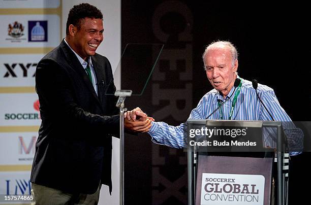 Ronaldo, former football star, greets Mario Jorge Lobo Zagallo, former football player and coach, after receiving a trophy for his career during the...