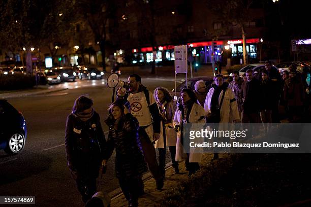Man uses a speaker amid other health workers during a demonstration at Puente de Toledo on December 4, 2012 in Madrid, Spain. All trade unions called...