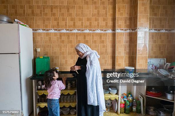 The mother and daughter of Said Ibrahim Abu Rial prepare to leave their house for the evening in the Shati Refugee Camp in Gaza on November 21, 2012....