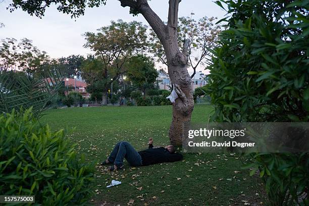 Guard takes a break in the garden behind the Shifa Hospital in Gaza City, Gaza on November 21, 2012. The front of the hospital is filled with...