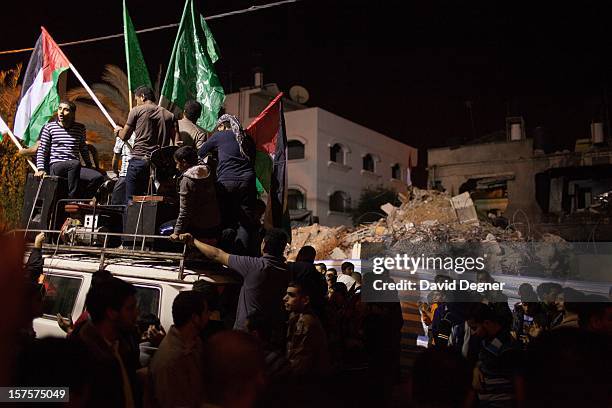 Celebrators stopped in front of the crumbled house of the Eldalo, where 11 people were killed by an Israeli attack in Gaza City, Gaza on November 21,...