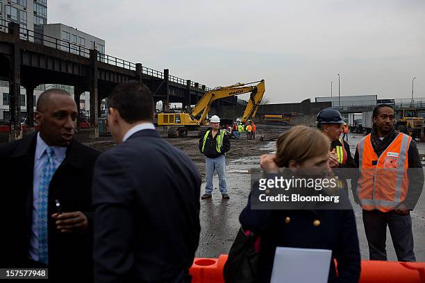 Construction workers stand as attendees gather for the start of the groundbreaking ceremony for the Hudson Yards development in New York, U.S., on...