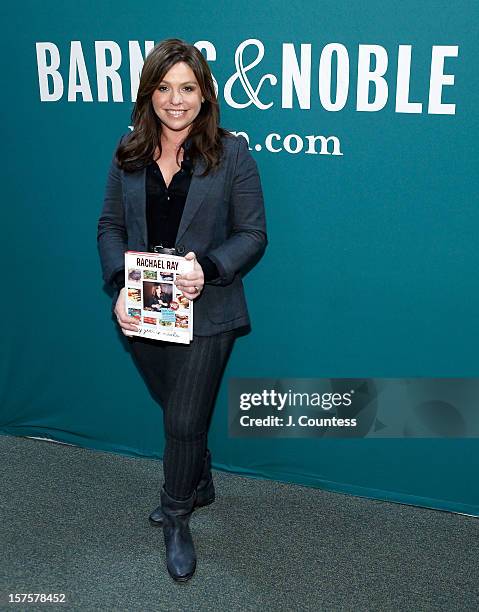 Chef and media personality Rachael Ray poses with a copy of her book "My Year In Meals" at Barnes & Noble Union Square on December 4, 2012 in New...