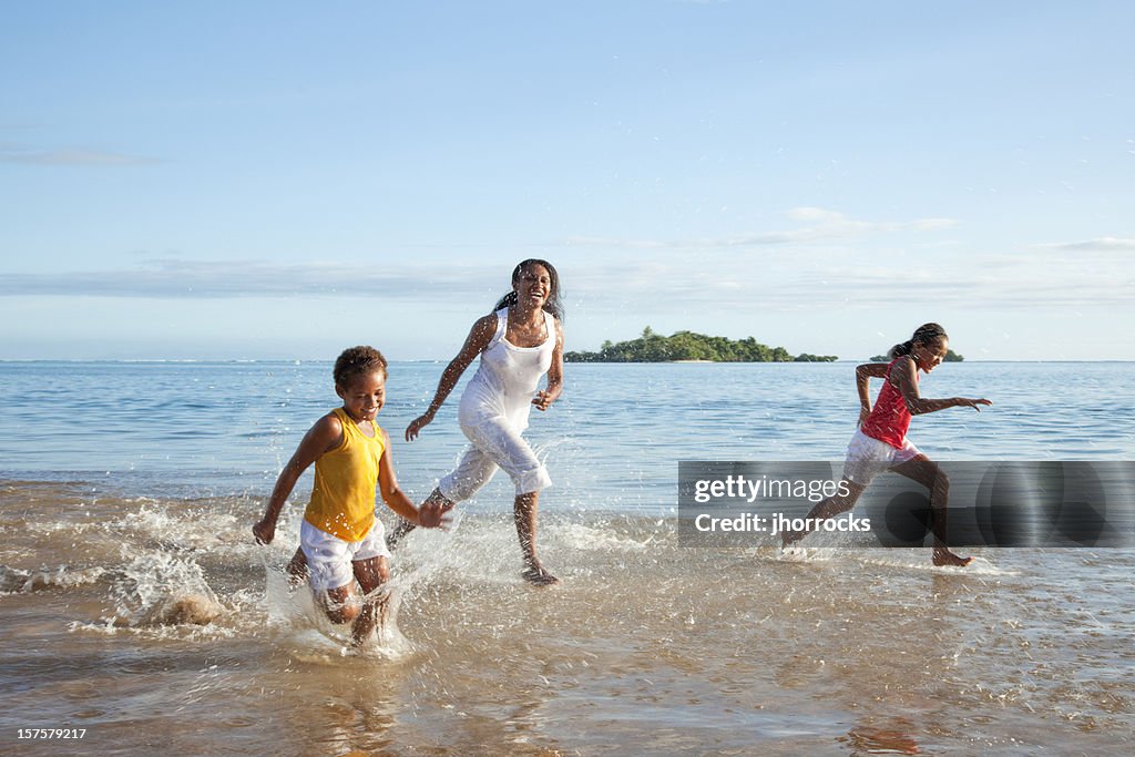 Fijian Mother and Daughters Running on Beach