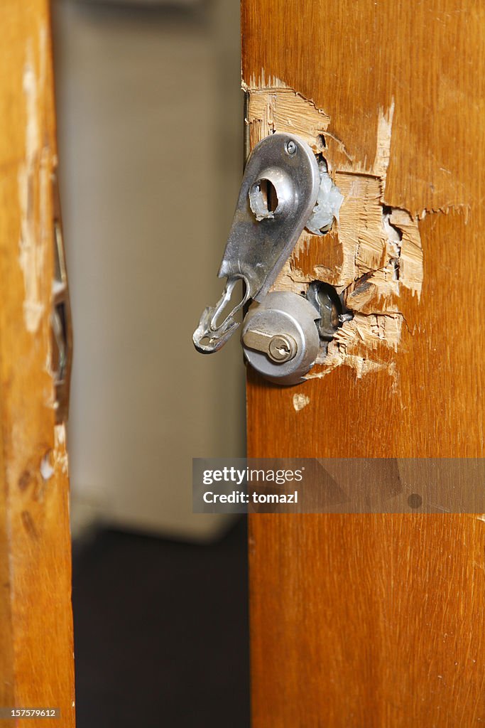 Broken lock and door frame damaged from break-in