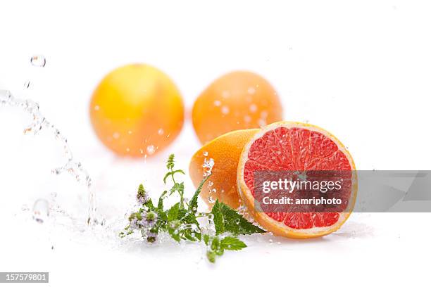 wet sliced grapefruit - citrus splash stock pictures, royalty-free photos & images