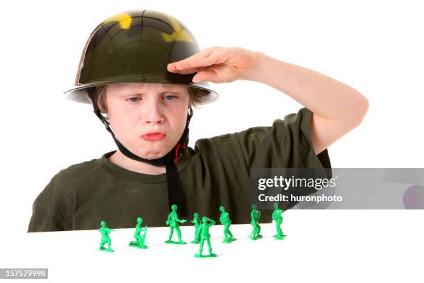 boy saluting green army men - child saluting stock pictures, royalty-free photos & images