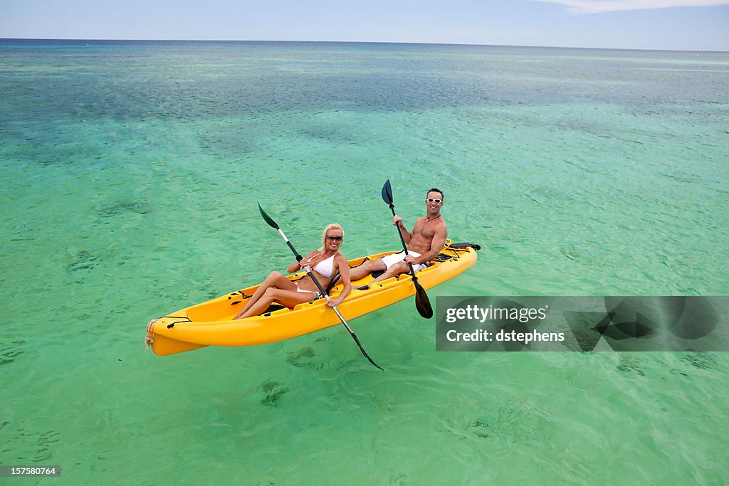 Happy couple kayaking in Caribbean Sea