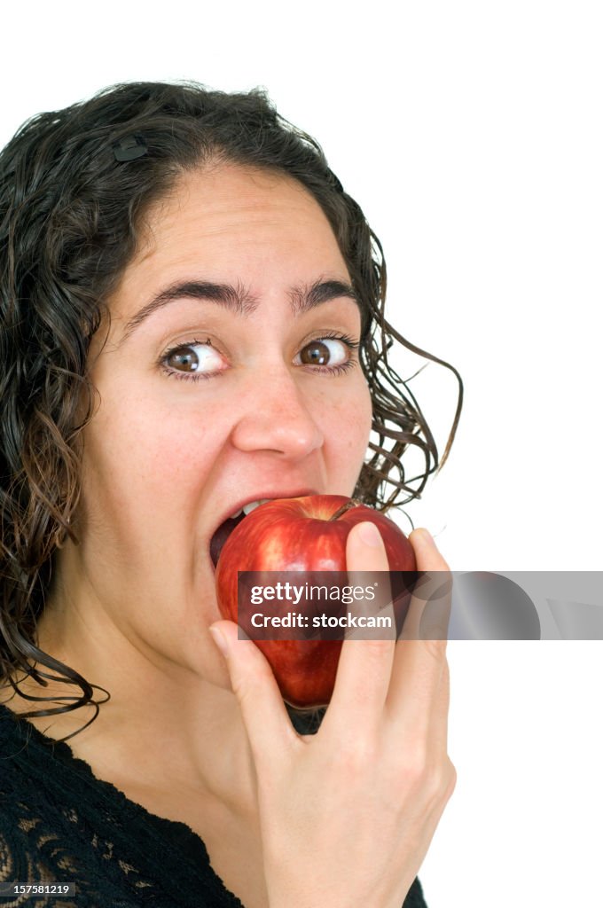 Woman eating red apple