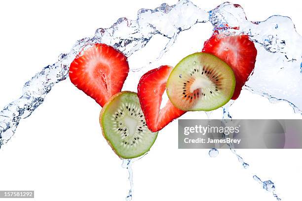 fresh kiwi and strawberry slices tossed with water, white background - flying kiwi stock pictures, royalty-free photos & images