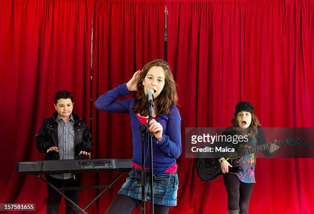 children rock band - girl singing stock pictures, royalty-free photos & images