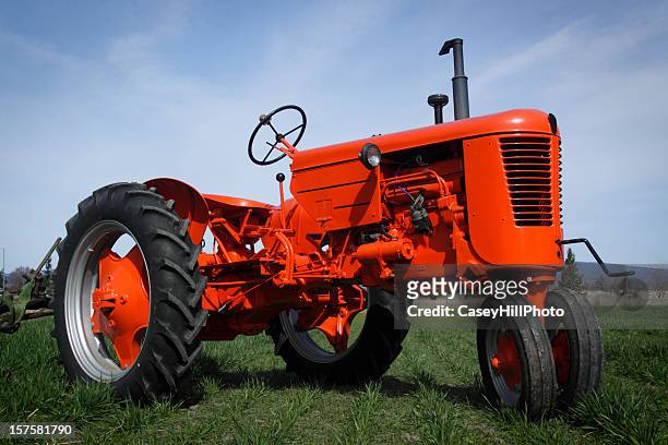 close up of a red tractor on grass - tractor repair stock pictures, royalty-free photos & images