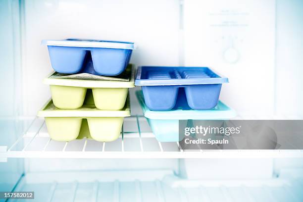 stacked ice cube trays in a freezer - freezer stock pictures, royalty-free photos & images