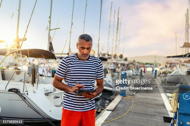 sailboat charter worker works in a harbor - ship captain stock pictures, royalty-free photos & images