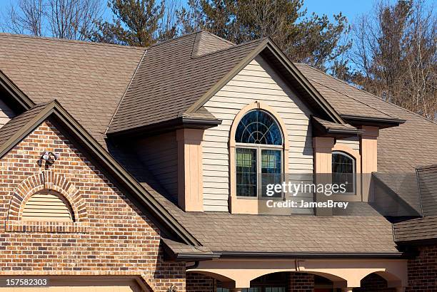 house with brick, vinyl siding, half-round windows, stucco accents - brick arch stock pictures, royalty-free photos & images