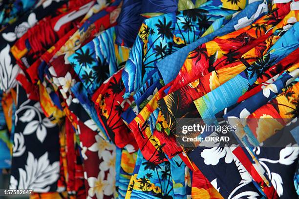 colorful shirts in traditional hawaii textiles background - gebloemd shirt stockfoto's en -beelden