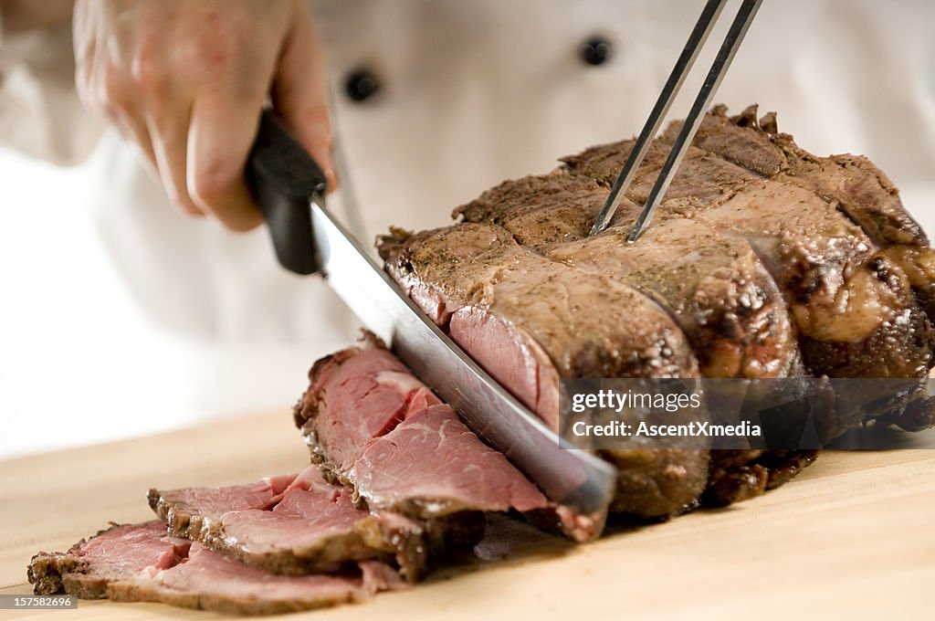 Chef Carving Perfectly Cooked Prime Rib Roast Beef High-Res Stock
