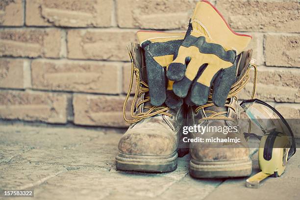still life containing work boots, gloves, and measuring tape - work boot stock pictures, royalty-free photos & images
