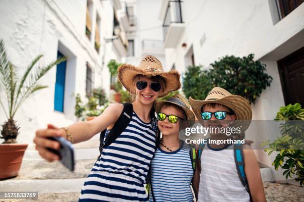 three kids sightseeing a town in andalusia, spain - frigiliana stock pictures, royalty-free photos & images