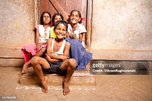 group of four cheerful rural indian children - rural scene stock pictures, royalty-free photos & images