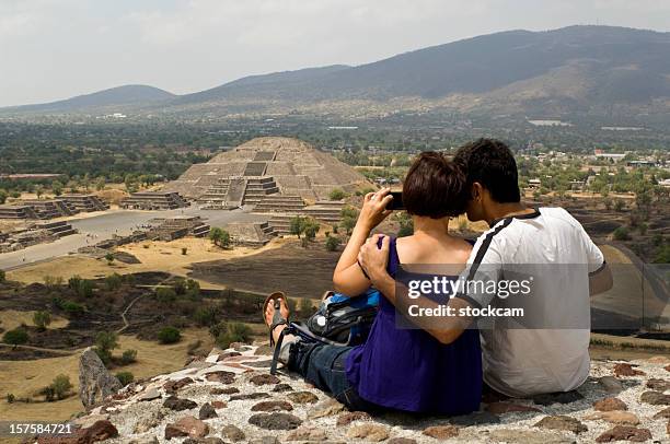 couple looking at pyramid of the moon in teotihuacan mexico - mexico city tourist stock pictures, royalty-free photos & images