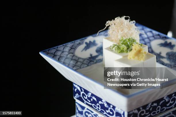 Hiyayakko, cubes of tofu, green onions, ginger, and bonito flakes, is a featured dish at the Sushi Jin Restaurant which is part of a Japanese cuisine...