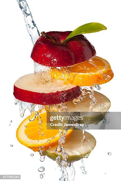 fresh fruit slices tossed in cool water, white background - apple water splashing stock pictures, royalty-free photos & images
