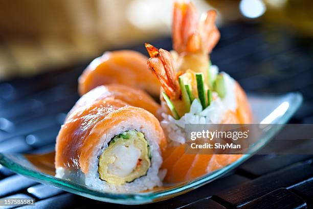 close-up photo of futomaki sushi on a blue plate - maki sushi stock pictures, royalty-free photos & images